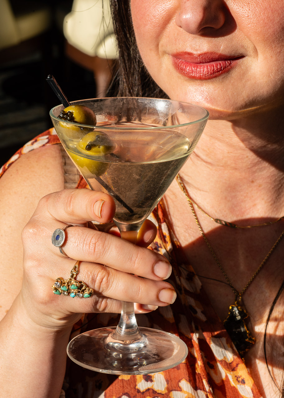 Close-up of a guest holding a martini.